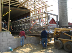 Moving modular dairy parlor unit into building